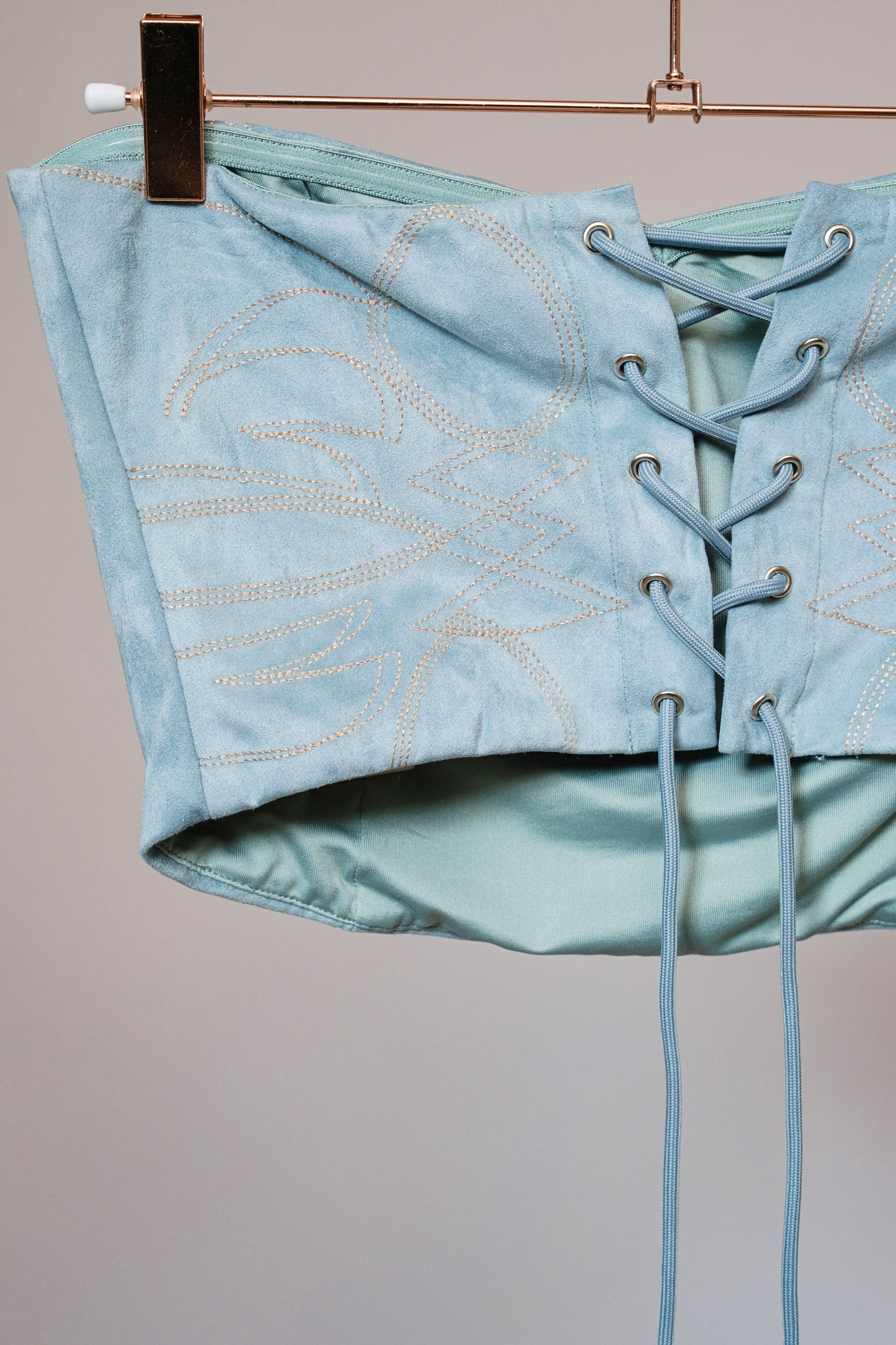 FAUX SUEDE BOOT STITCH STUDDED CORSET TOP in GREY BLUE